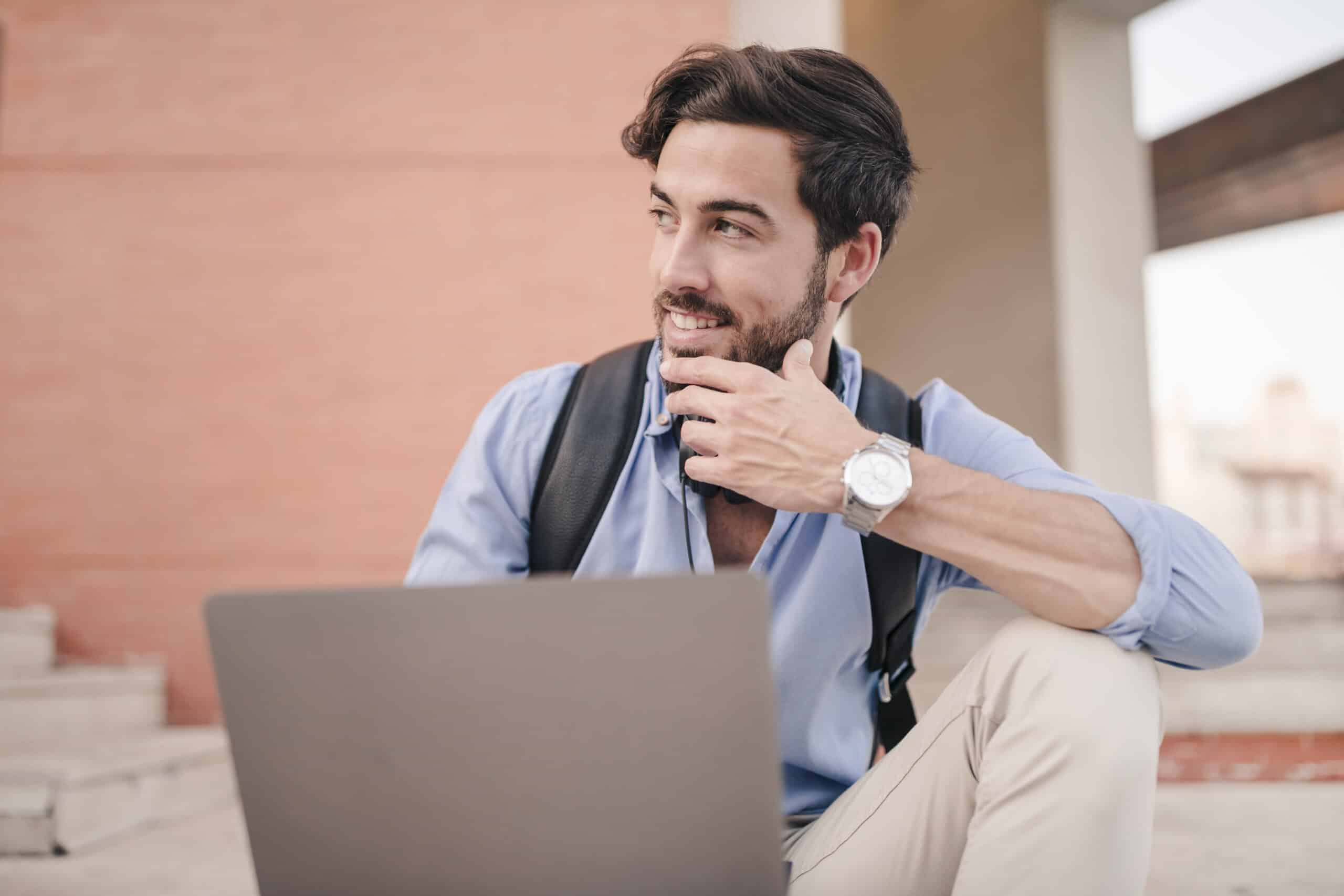 happy-man-with-laptop-looking-away